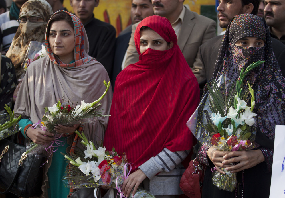 Pakistani women pay tribute to students and staff members killed in an attack by Taliban gunmen, as they gather outside the school in Peshawar on Wednesday.