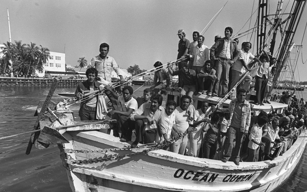 A shrimp boat returning from Mariel, Cuba, is packed with Cuban refugees as it lands at Floriday's Key West Naval Base on April 30, 1980.  President Jimmy Carter said in May 1980 that Cubans leaving the port of Mariel would be welcomed in the United States with "open hearts and open arms." That was after Castro opened the port in April 1980 to anyone who wanted to go. A few weeks later, Carter ordered the "freedom flotilla" stopped as America was overwhelmed by an average of 1,000 new arrivals daily. (AP Photo)