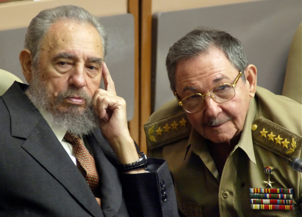 FILE - In this July 31, 2004 file photo, Cuba's President Fidel Castro, left, and his brother, Minister of Defense Raul Castro, attend a Parliament session in Havana, Cuba. The 1991 collapse of the Soviet Union devastated the Cuban economy, but the country limped along, first under Fidel and then, after he fell ill in 2006, under his brother Raul, head of the Cuban military. On Wednesday, Dec. 17, 2014, the U.S. and Cuba agreed to re-establish diplomatic relations and open economic and travel ties, marking a historic shift in U.S. policy toward the communist island after a half-century of enmity dating back to the Cold War. (AP Photo/Cristobal Herrera, File)