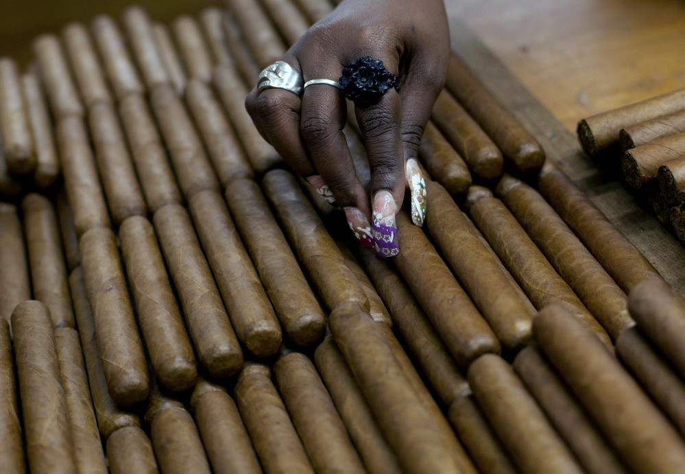 FILE - In this March 1, 2013 file photo, a worker selects cigars at the H. Upmann cigar factory, where people can take tours as part of the 15th annual Cigar Festival, in Havana, Cuba. Among those eager for access to a Cuban market cut off by an economic embargo are U.S. farmers, travel companies, energy producers and importers of rum and cigars. (AP Photo/Ramon Espinosa, File)