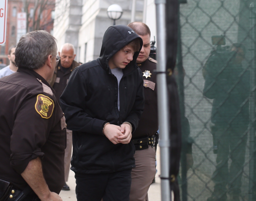 Justin Woodbury, the juvenile accused of making email threats against RSU 14, arrives for his initial court appearance in Portland in December 2014.