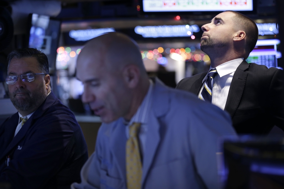 Traders work on the floor at the New York Stock Exchange in New York on Thursday. Even the energy sector advanced, despite another drop in the price of oil, as bullish earnings from the technology giant Oracle help drive the rally.