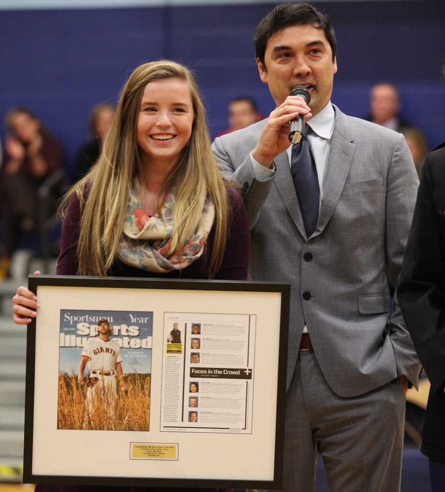 York soccer player Kate Marshall receives a plaque from Chris Stone, managing editor of Sports Illustrated, in recognition of her selection as the magazine’s High School Athlete of the Month for December. Marshall, a sophomore, was a starting midfielder for the Wildcats this fall and plays year-round for a club team despite having cystic fibrosis.