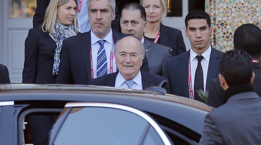 FIFA president Sepp Blatter, center, leaves his hotel to lead a meeting of the soccer governing body’s executive committee in Morocco. FIFA faces criticism for its lack of transparency.