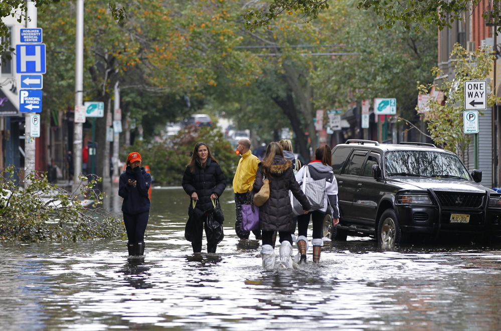 The power of Hurricane Sandy was clear to residents of Hoboken, N.J., as they waded through floodwaters on Oct. 31, 2012. The monster storm crippled transportation, knocked out power for millions and killed at least 45 people in nine states.