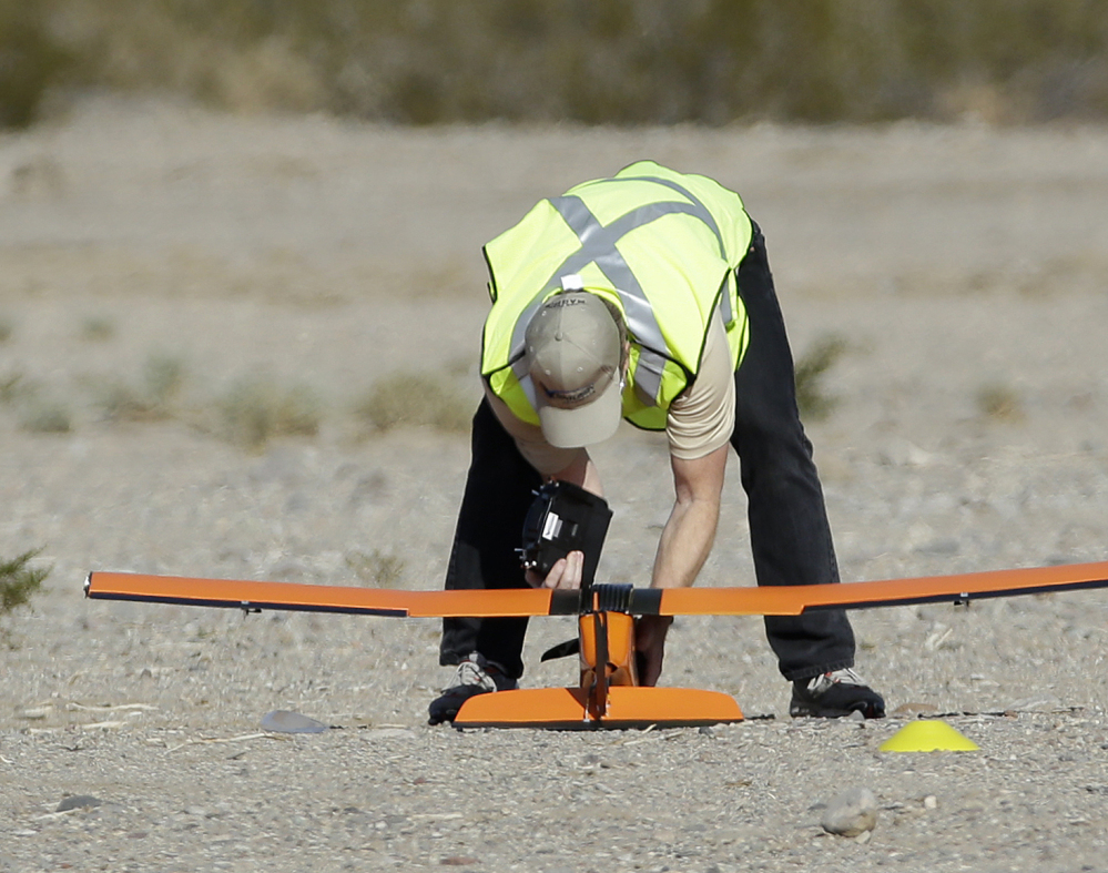 Scott Carrigan of Sensurion Aerospace picks up the company’s Magpie commercial drone after it crashed during launch Friday near Boulder City, Nev.