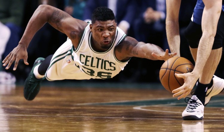 Celtics guard Marcus Smart goes to the floor as Minnesota Timberwolves forward Robbie Hummel picks up the loose ball during the second half of Friday night’s 114-98 win by the Celtics.