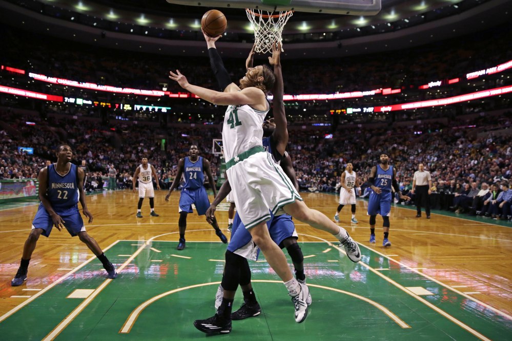 Boston Celtics center Kelly Olynyk shoots a reverse layup on a drive to the basket against the Minnesota Timberwolves during the first quarter of Friday night’s game in Boston. Olynyk finished with 21 points.