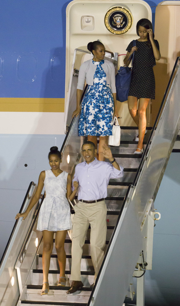 The Obamas disembark Air Force One after arriving at Joint Base Pearl Harbor-Hickam for their annual Christmas vacation Friday in Honolulu. The first family will be staying in Kailua.