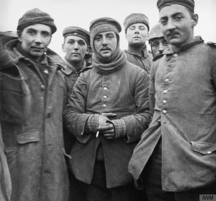 In this image provided by the Imperial War Museum, World War I German and British soldiers stand together on the battlefield near Ploegsteert, Belgium during Dec. 1914. Soldiers who had been killing each other by the tens of thousands for months climbed out of their soggy trenches to seek a shred of humanity amid the horrors of World War I. Hands reached out across the divide and in Flanders Fields a century ago, a spontaneous Christmas truce ever so briefly lifted the human spirit.