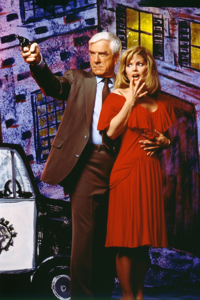 This 1988 publicity photo shows actor Leslie Nielsen, left, with actress Priscilla Presley in the film, “The Naked Gun: From the Files of Police Squad!”