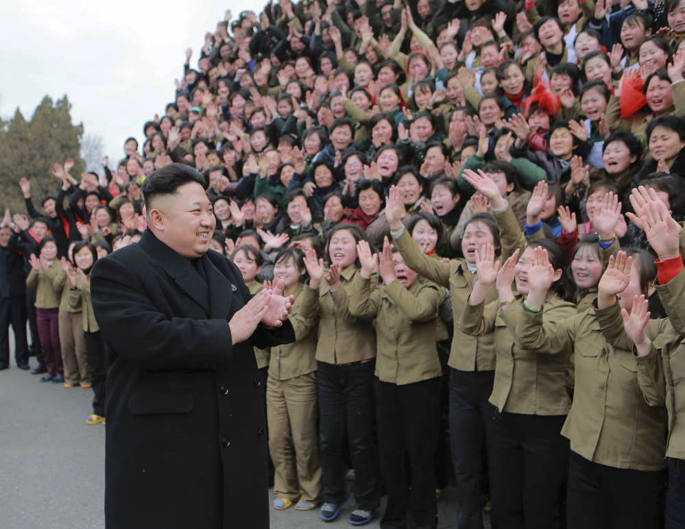 Kim Jong Un greets a crowd in Pyongyang, North Korea. His government denies responsibility for a cyberattack on Sony Pictures Entertainment.