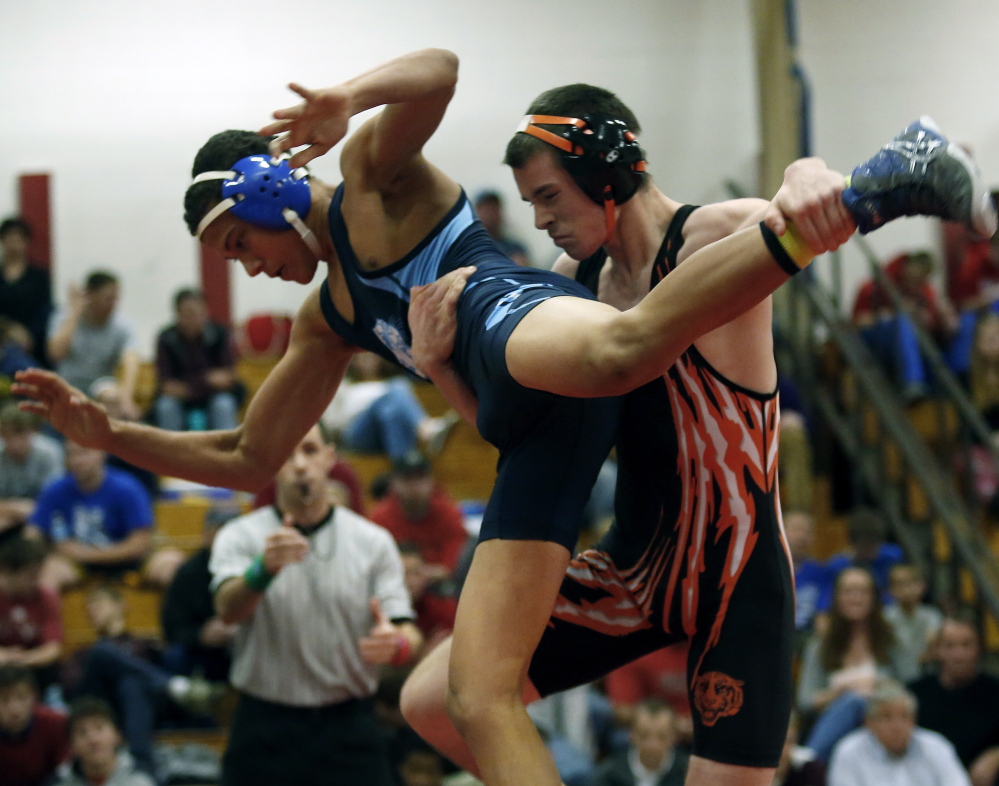 Brian Livermore of Biddeford takes down Hunter White of Dirigo during the 138-pound final Saturday at the Atlantic Invitational in Wells. Livermore won the match, 12-8, and was chosen as the meet’s outstanding wrestler.