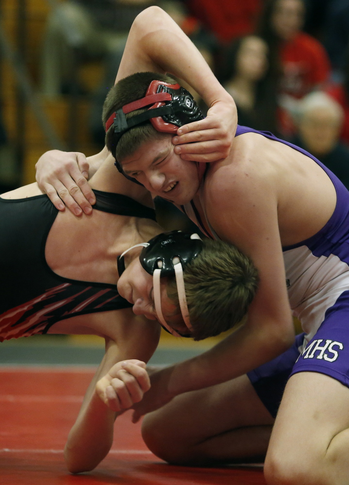 Sam Hebert, right of Marshwood, right, battles with Charlie Durfee of Wells during the 145-pound final. Hebert earned a 16-3 decision and was one of eight individual champions for Marshwood, which more than doubled the point total of runner-up Dirigo.