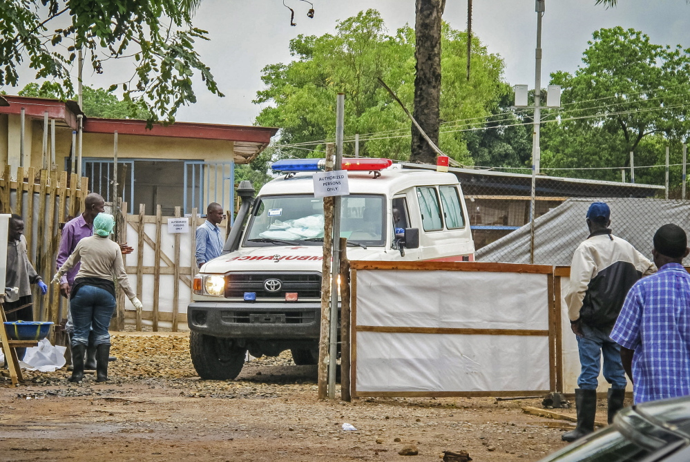 An ambulance leaves an Ebola isolation unit at the Kenema Government Hospital in Kenema, Sierra Leone, carrying the highly contagious bodies of the dead to a burial site.