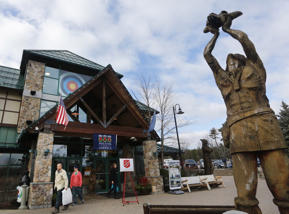 Shoppers carrying purchases leave Kittery Trading Post on Saturday.