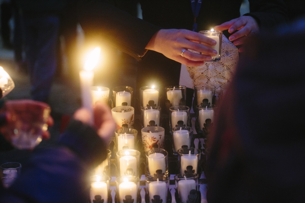 People light candles in memory of the members of Portland’s homeless community who died this year.