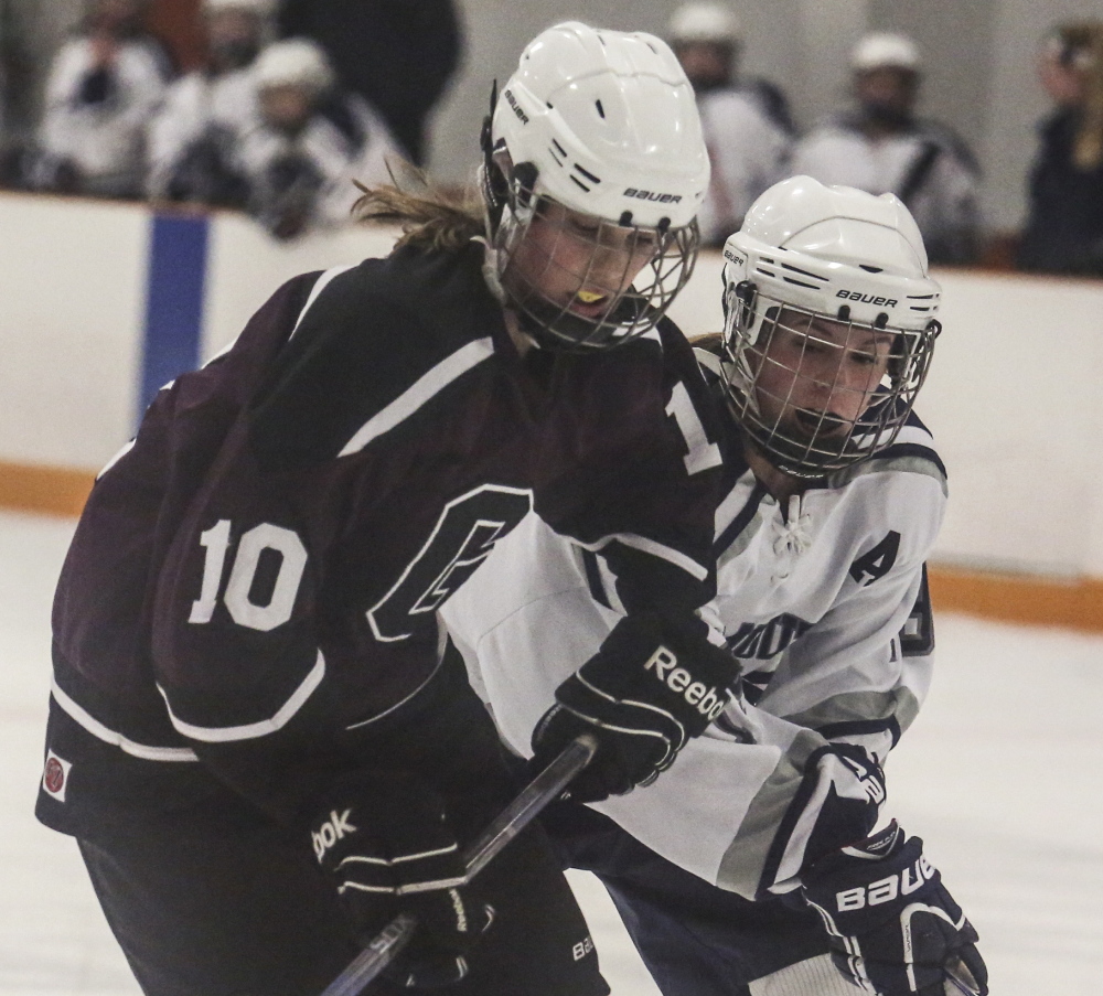 Greely’s Courtney Sullivan skates with the puck as Yarmouth/Freeport’s Emily Johnson defends during the Rangers’ 5-3 win Monday in Yarmouth.