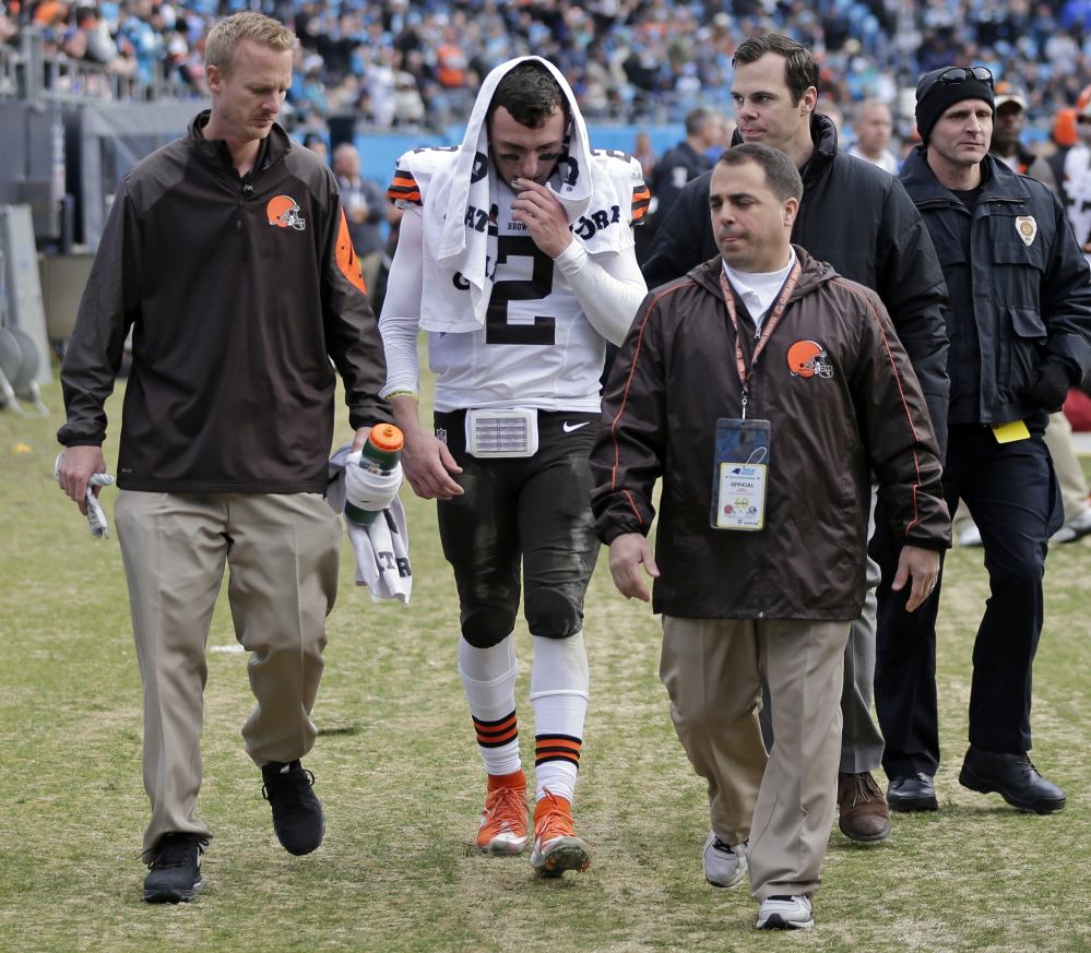 The Cleveland Browns’ Johnny Manziel is helped off the field after being injured in the first half of Sunday’s game against the Carolina Panthers. Manziel’s rookie season in the NFL wasn’t what he or the Browns or his legion of fans expected. He started one game, couldn’t make it through his second without getting hurt, and didn’t look like a franchise-changing quarterback.