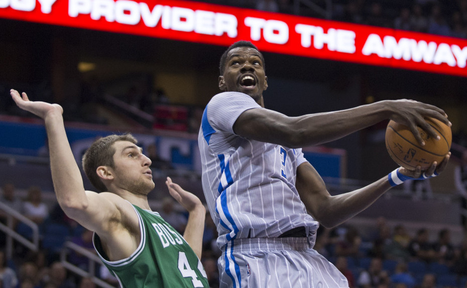Orlando’s Dewayne Dedmon looks to shoot past Boston’s Tyler Zeller during the first half of Tuesday night’s game in Orlando, Fla. Zeller led the Celtics with 22 points and 10 rebounds.