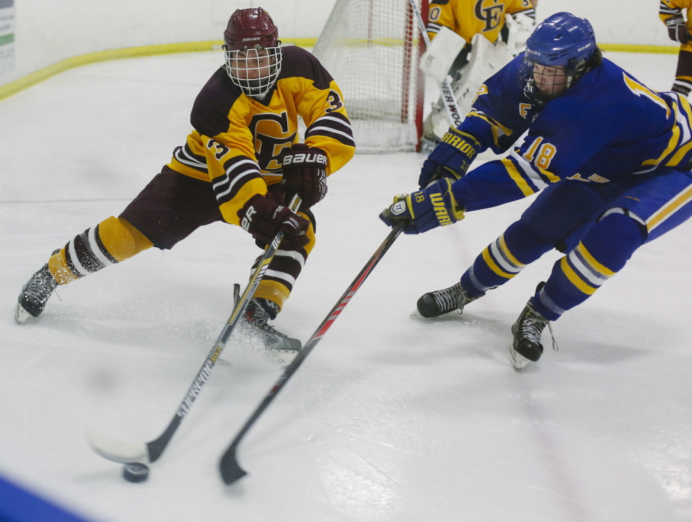 Peyton Weatherbie of Cape Elizabeth, left, attempts to slip the puck past Isaac Nordstrom of Falmouth during their schoolboy hockey game Tuesday night at the Portland Ice Arena. Falmouth remained unbeaten with a 3-2 victory.
