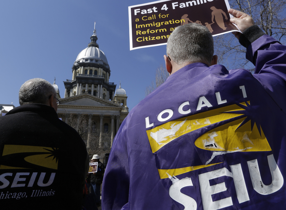 Members of the Service Employees International Union rally in March in front of the Illinois State Capitol in support of immigration reform. Unions across the country are reaching out to immigrants affected by President Obama’s recent executive action in hopes of expanding their dwindling ranks by recruiting millions of workers who entered the U.S. illegally.