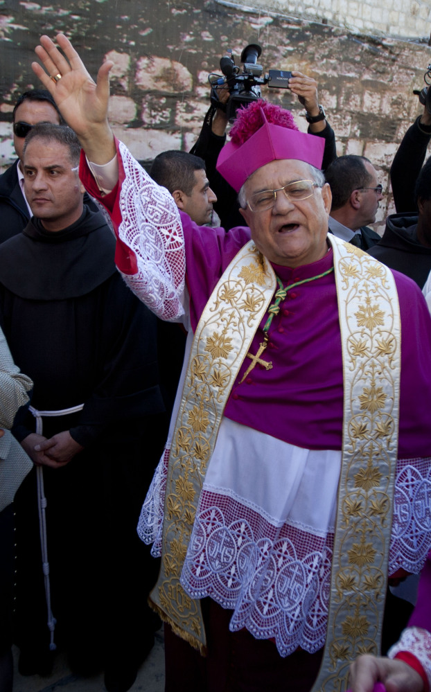 Latin Patriarch of Jerusalem Fouad Twal waves as he arrives at the Church of the Nativity in Bethlehem on Wednesday.