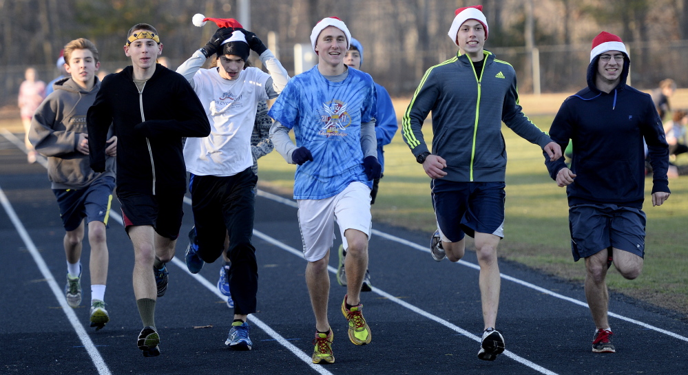 Tucker Corbett, center, has been part of a York High indoor track team that won states titles in his first two seasons and was runner-up last year. One reason is the depth on the team – about 120 students in the indoor program, all overseen by Coach Ted Hutch.