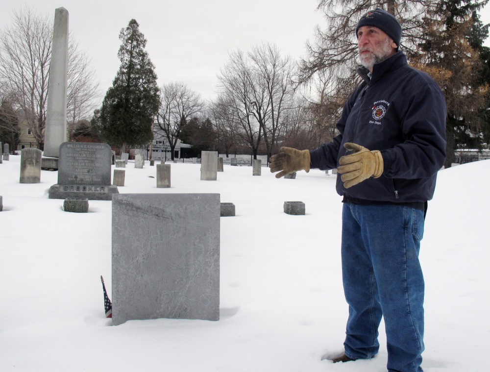 Art Cohn of the Lake Champlain Maritime Museum stands in front of the grave of War of 1812 hero Joseph Barron Jr., in Burlington, Vt. Cohn says the grave was dug up in 1906 to determine whether Barron’s remains were really in his home state.