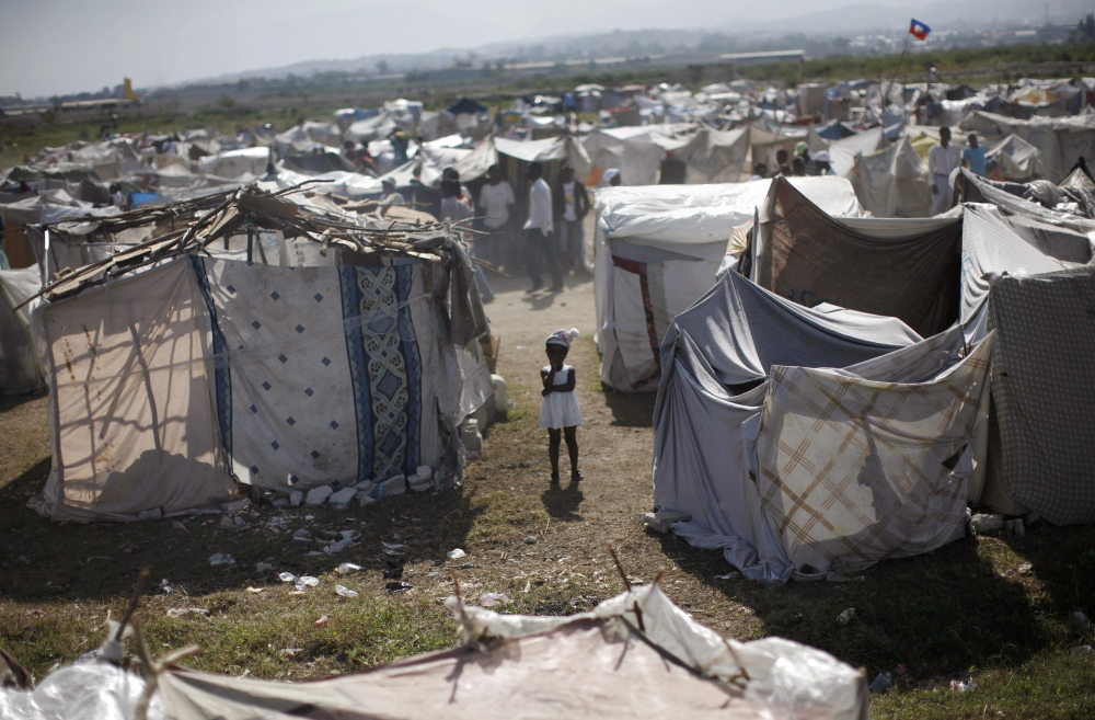 A child stands among makeshift tents at a refugee camp for earthquake survivors in the Cite Soleil neighborhood of Port-au-Prince in 2010, after a magnitude-7.0 quake struck the island and killed an estimated 300,000 people.