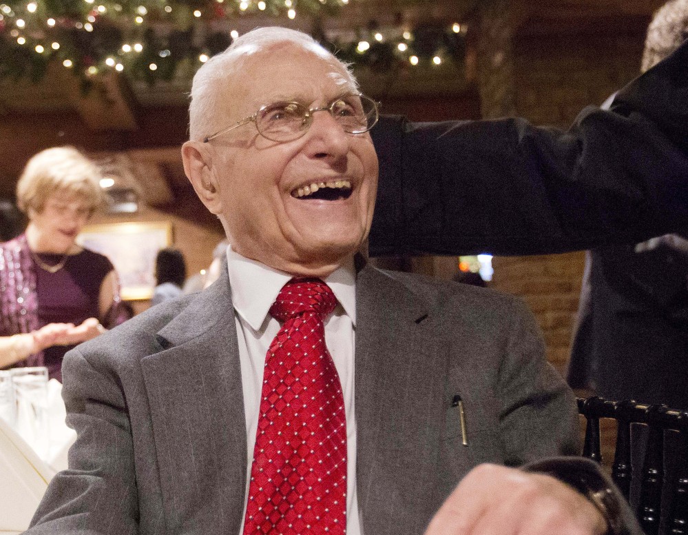 Charlie Ponti laughs during a holiday party in New York. The 101-year-old is finally ready to retire Dec. 31.