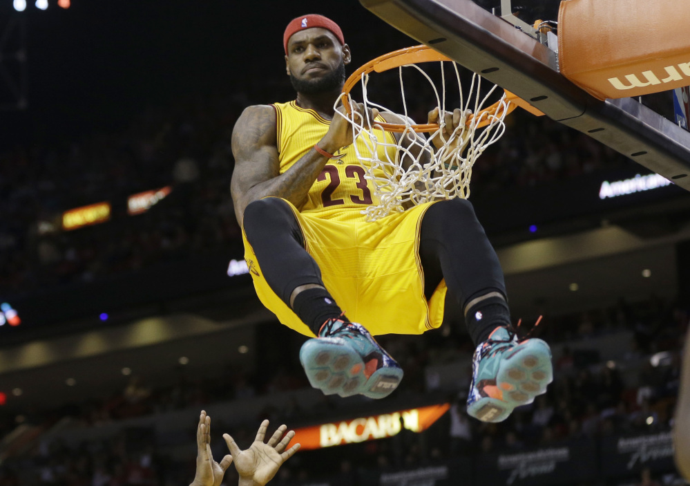 LeBron James hung around Miami for four seasons. Thursday, he was simply hanging on the rim after a dunk. And yes, it was a technical. James, now back with Cleveland, scored 30 points in a loss in his return to Miami.