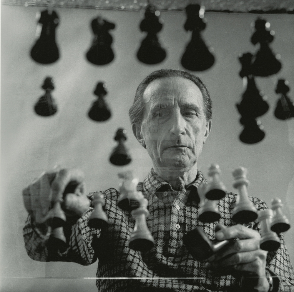Portrait of Duchamp playing chess at his 14th Street Studio in New York in 1958. Gelatin silver print by Arnold T. Rosenberg.