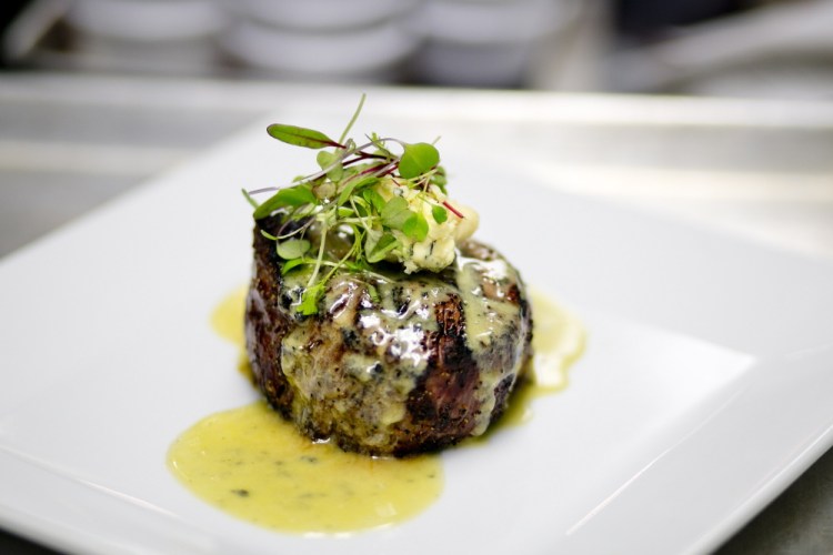 The filet mignon is adorned simply with a scoop of Stilton and a smattering of greens.