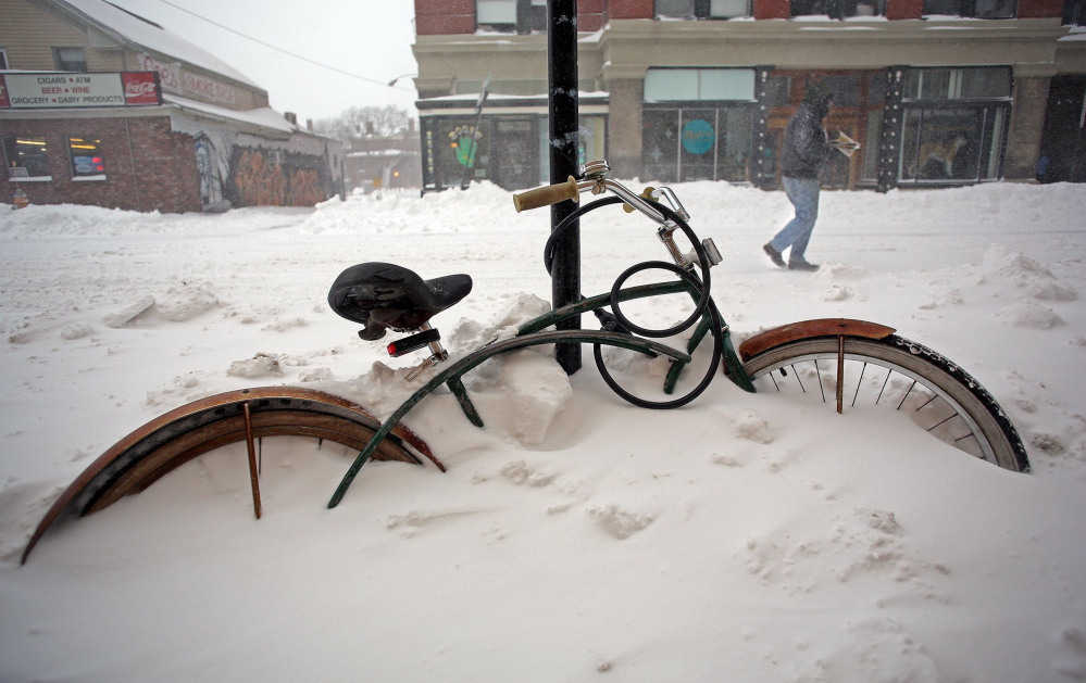 A mid-December snowstorm buried this bicycle on Congress Street in Portland last winter.