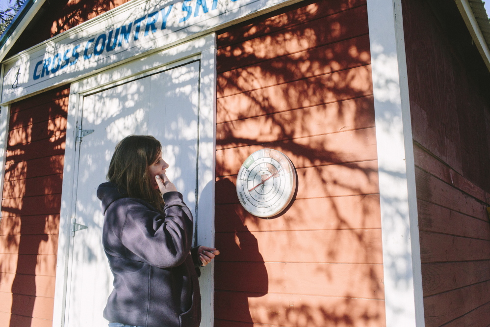 Hillary Knight looks at a temperature gauge at Smiling Hill Farm in Westbrook, where the cross-country ski trails were open for three days after Thanksgiving. “Everything’s ready,” she said. “We’re just waiting for snow.”