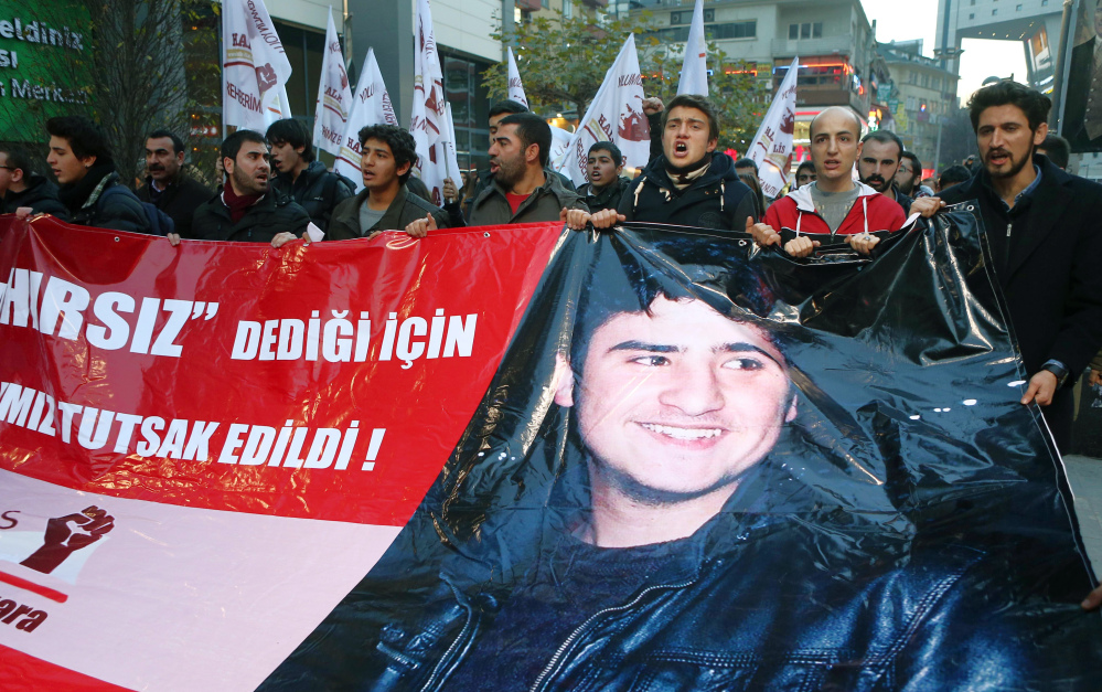 Students carry a banner with an image of a Turkish teen, known as M.E.A., that reads, “Our friend was taken prisoner for calling a thief a thief” during a protest in Ankara on Friday.