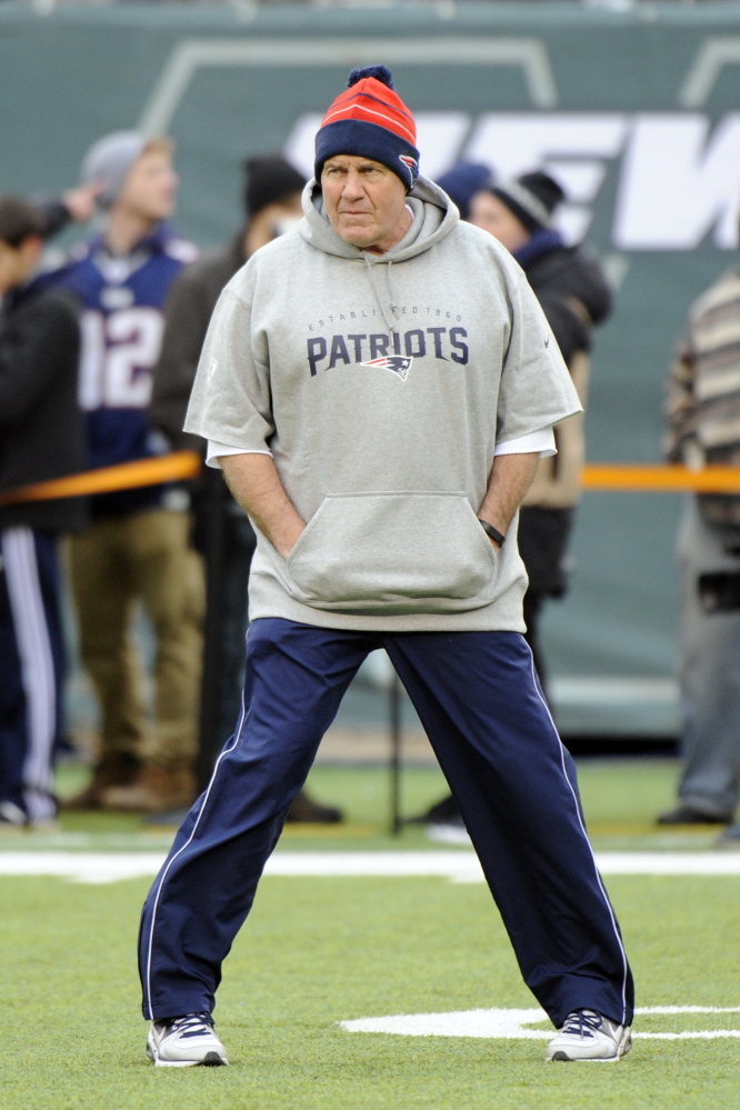 New England Patriots coach Bill Belichick looks on as his team warms up before an NFL football game against the New York Jets on Dec. 21 in East Rutherford, N.J. The Associated Press