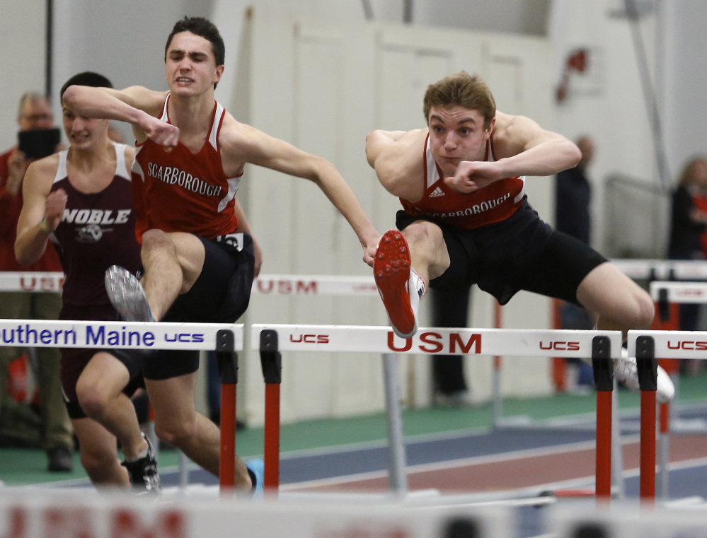 Griffin Madden of Scarborough, right, is followed by his teammate Maxim Doiron as they head to the line for a 1-2 finish Saturday in the 55-meter hurdles at the USM New Year’s Relays indoor track meet.