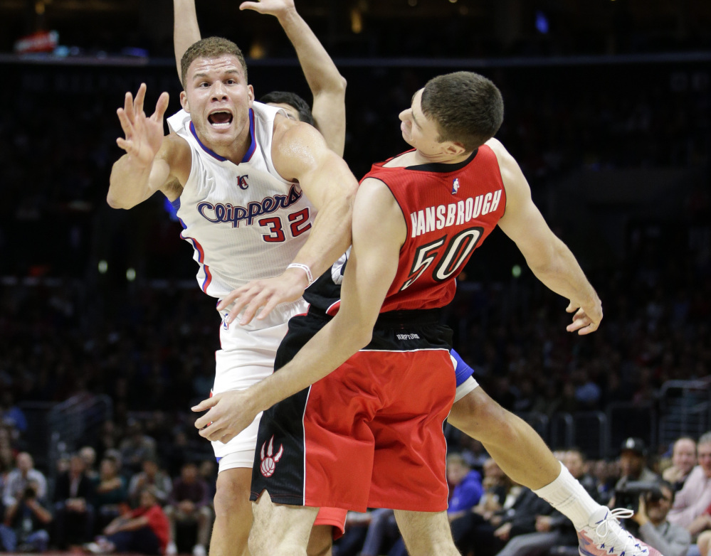 Clippers’ forward Blake Griffin, left, is fouled by Raptors’ forward Tyler Hansbrough during Toronto’s 110-98 win Saturday in Los Angeles.
