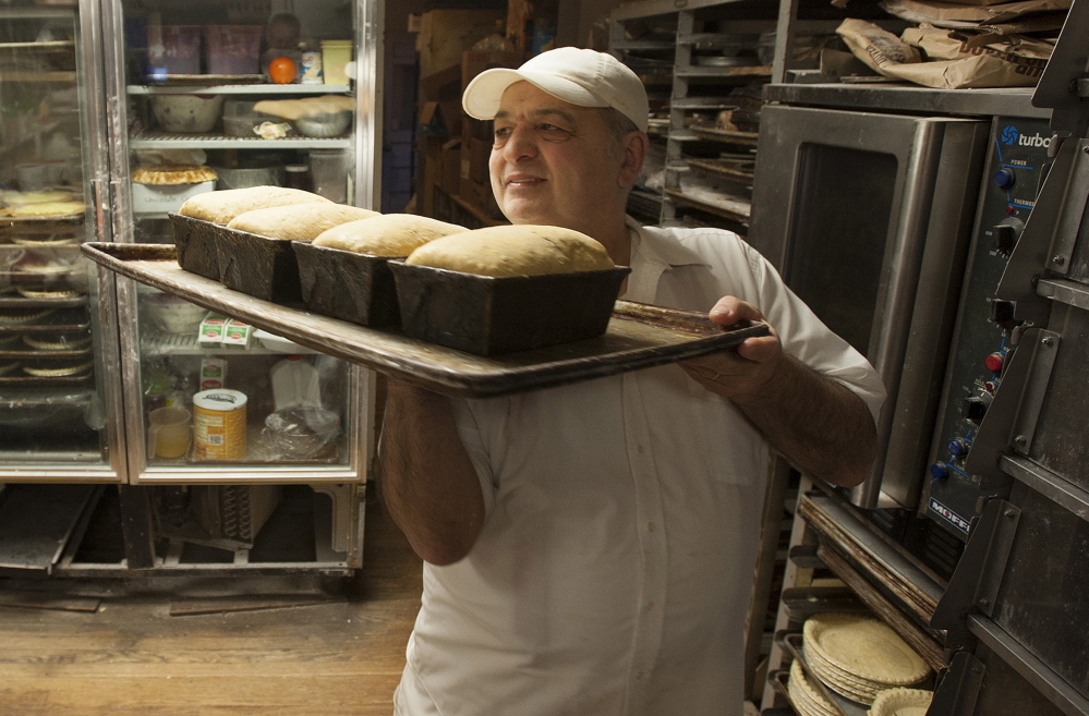 Daryl Buck removes bread from an oven at Hillman’s Bakery in Fairfield on Tuesday morning.