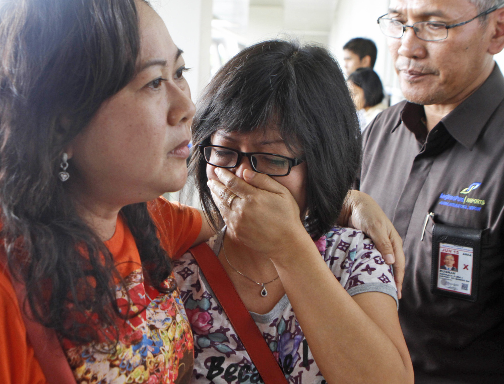 A relative of AirAsia flight 8501 passengers weeps as she waits for the latest news on the missing jetliner at Juanda International Airport in Surabaya, East Java, Indonesia, on Sunday.