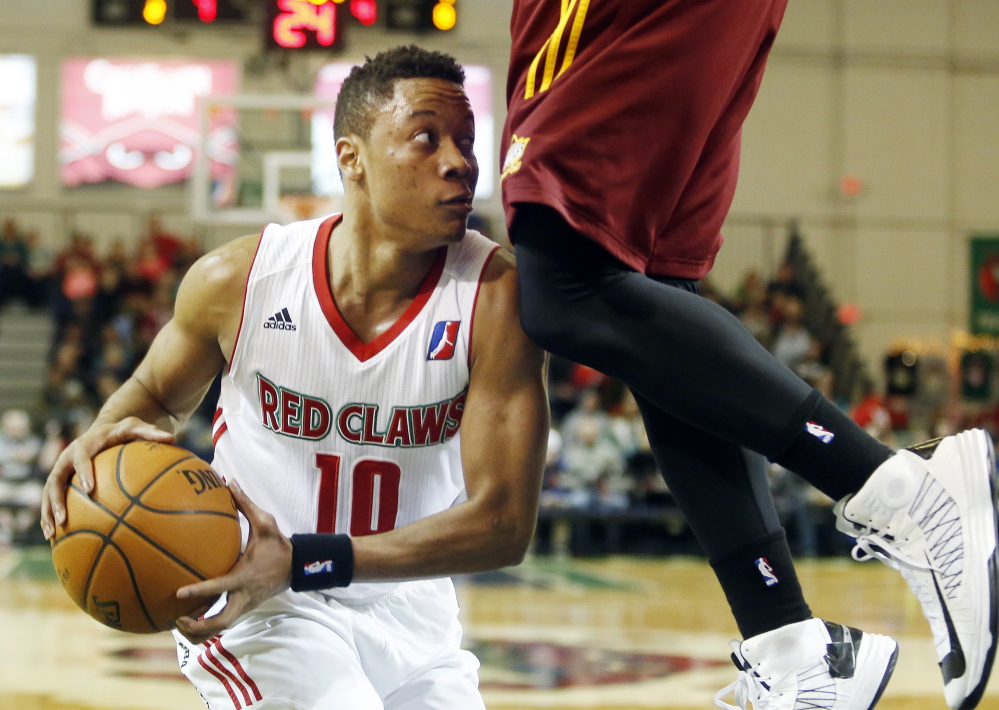 Maine’s Tim Frazier tries to find someone to pass to with a Canton Charge defender high above him. Frazier scored 15 points on Sunday, but the Red Claws suffered their first loss at home this season, 99-98.