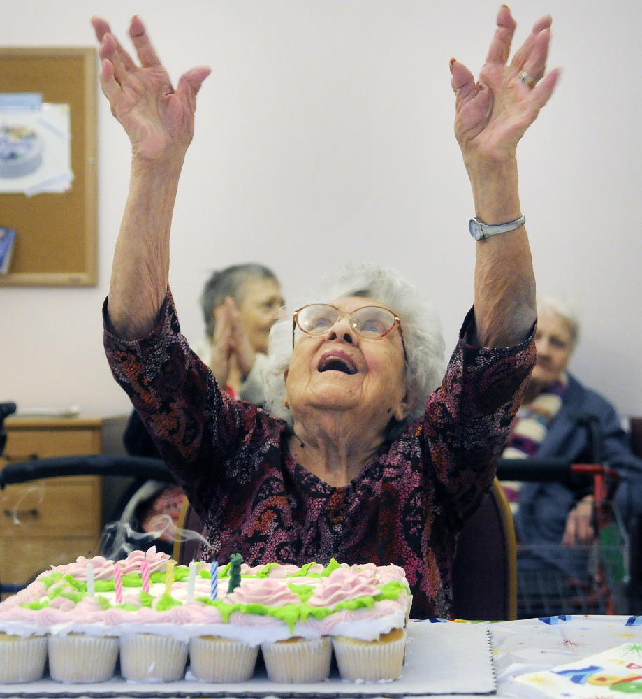 Gertrude Virgin gives thanks Sunday as her family and friends help celebrate her 106th birthday at the Alzheimer’s Care Center in Gardiner.