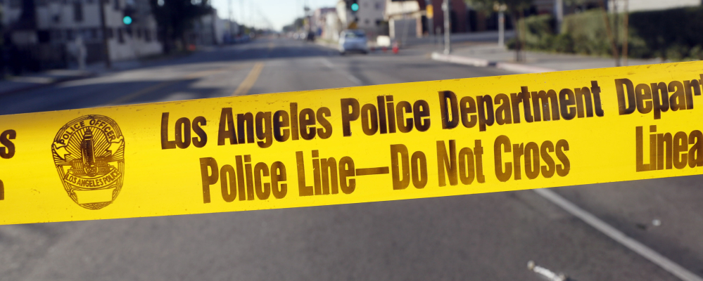 Crime scene tape stretches across a street in South Central Los Angles on Monday after police officers were shot at on Sunday. The area is plagued by gang violence.