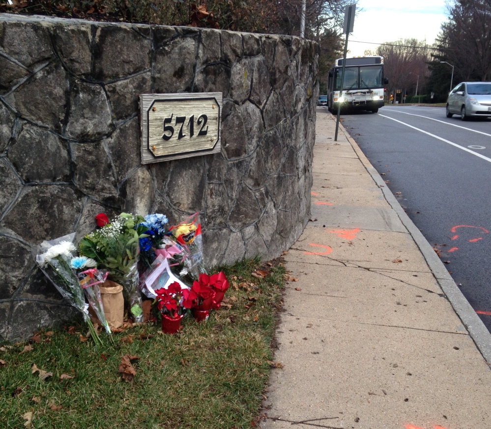 Flowers mark the site where a bicyclist was hit Saturday in Baltimore. An Episcopal bishop returned “to take responsibility for her actions,” one of her peers says.
