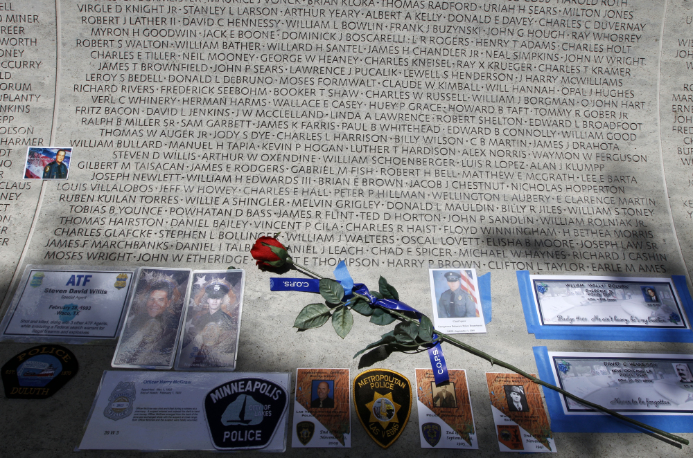 A rose is placed at the wall with the names of fallen police officers at the National Law Enforcement Officers Memorial in Washington during National Police Week in May.