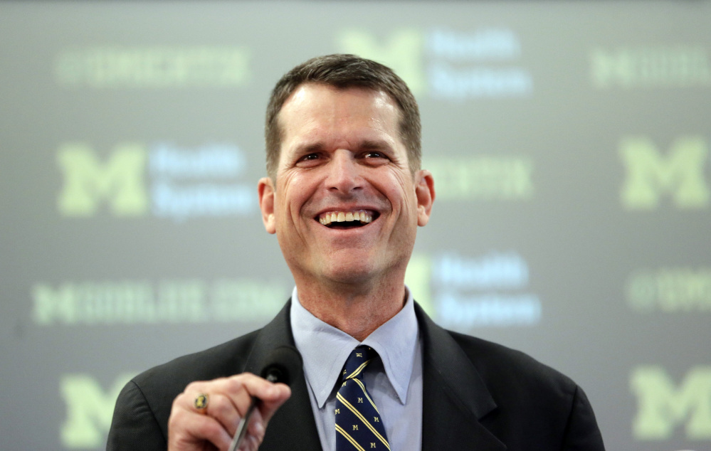 Jim Harbaugh, Michigan’s new head football coach, addresses the media after after he was introduced during an NCAA college football news conference Tuesday, in Ann Arbor, Mich.