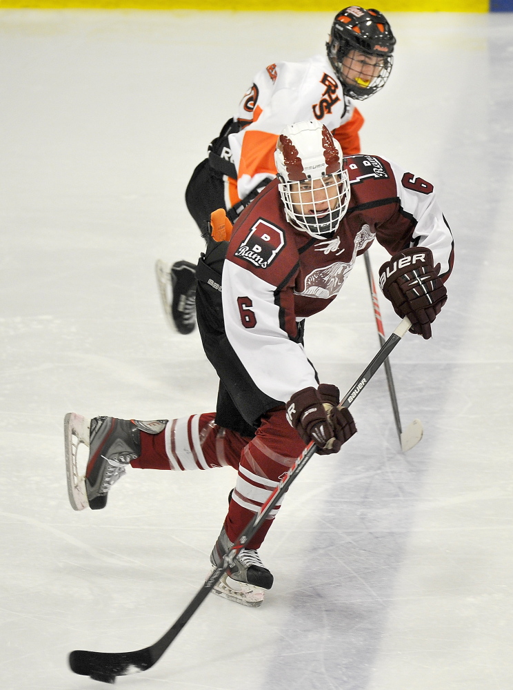 Bangor's Trevor DeLaite looks for an open man while being chased by a Biddeford opponent . 

