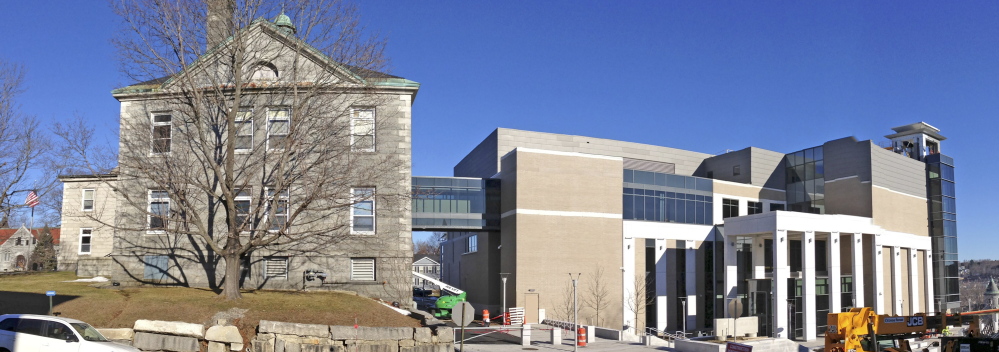The old Kennebec County Courthouse, at left, will be renovated in the coming months, and construction of the new Capital Judicial Center in Augusta, at right, is nearly complete.